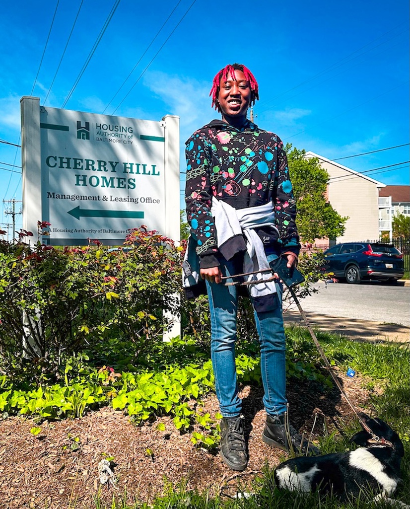 Cherry Hill resident accompanied by her puppy in front of a small Cherry Hill Homes sign